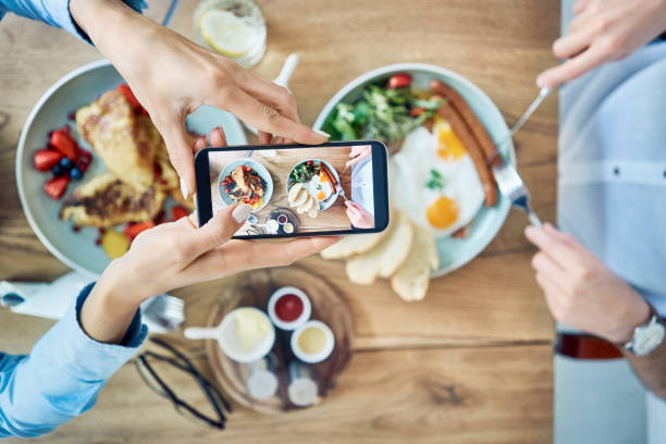 Someone taking picture of their food at a restaurant to post on social media.